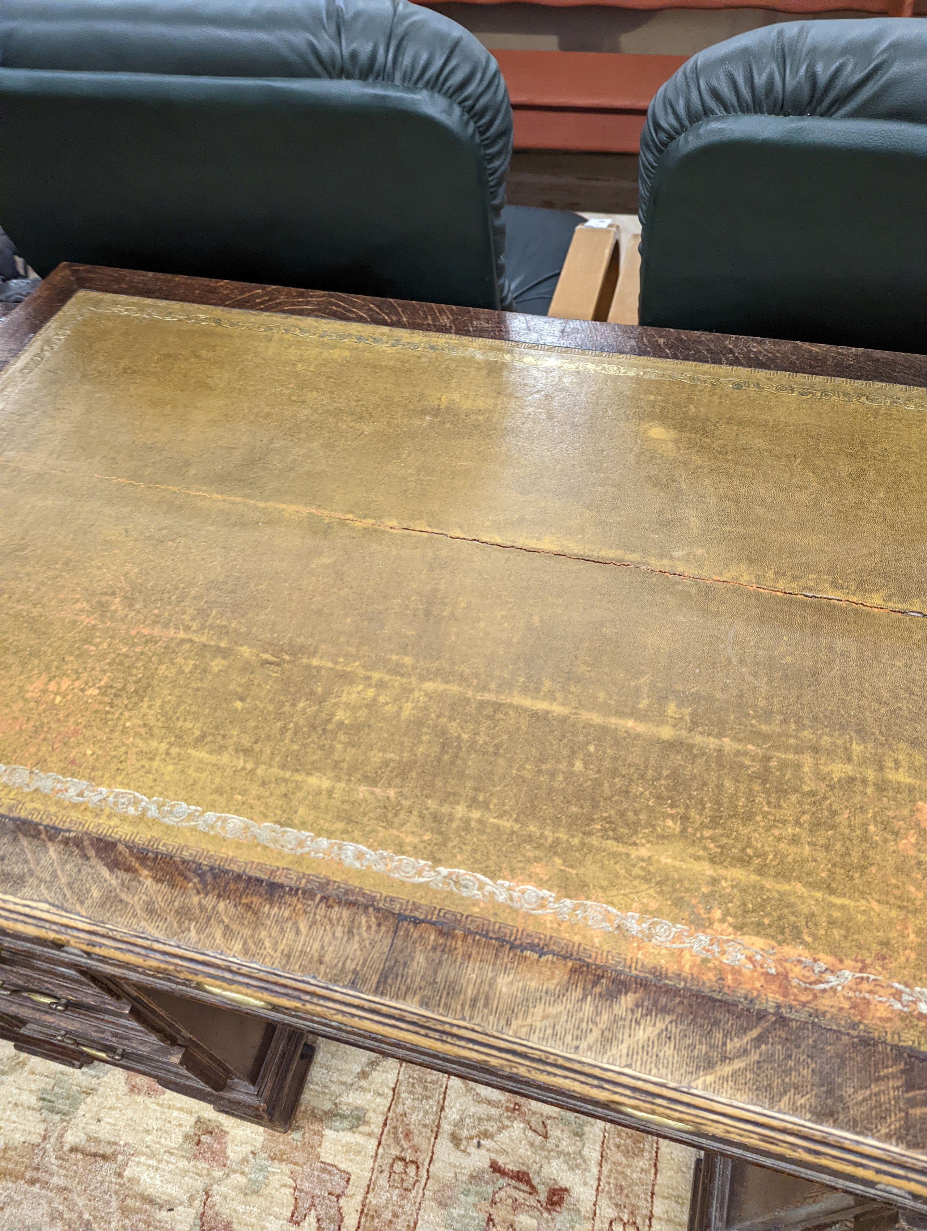 An early 20th century oak kneehole desk, length 122cm, depth 66cm, height 75cm